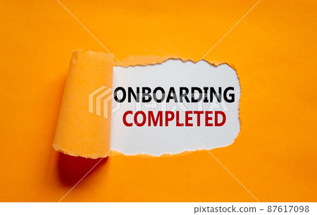 Onboarding completed symbol. Words 'Onboarding completed' appearing behind torn orange paper. Beautiful orange background. Business, onboarding completed concept, copy space. Onboarding completed symbol. Words 'Onboarding completed' appearing behind torn orange paper. Beautiful orange background. Business, onboarding completed concept, copy space. 87617098