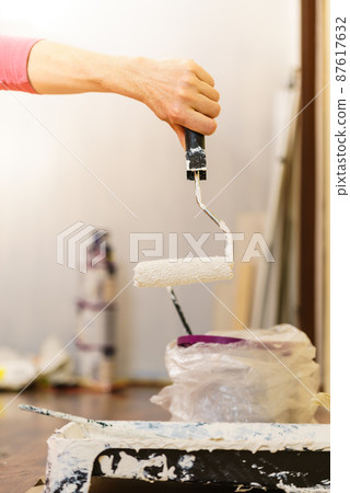 White paint with roller brush White paint with roller brush 87617632