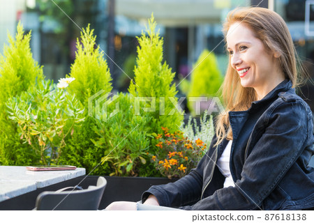 Woman waiting in outdoor restaurant cafe. Woman waiting in outdoor restaurant cafe. 87618138