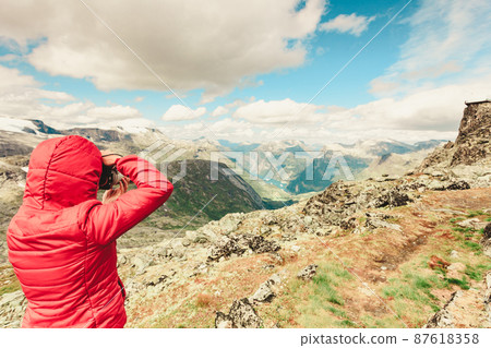 Tourist taking photo from Dalsnibba area Norway 87618358