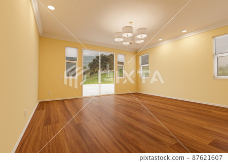 Newly Remodeled Room of House with Finished Wood Floors, Moulding, Light Yellow Paint and Ceiling Lights. Newly Remodeled Room of House with Finished Wood Floors, Moulding, Light Yellow Paint and Ceiling Lights. 87621607
