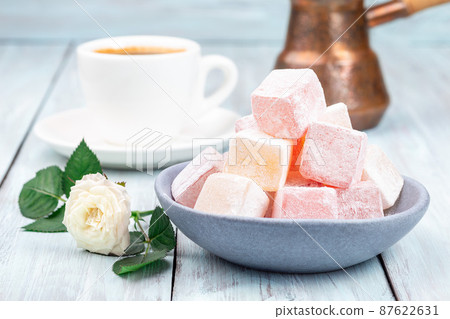 Turkish delight or lokum confection rose and lemon flavored with cup of coffee and cezve, horizontal Turkish delight or lokum confection rose and lemon flavored with cup of coffee and cezve, horizontal 87622631