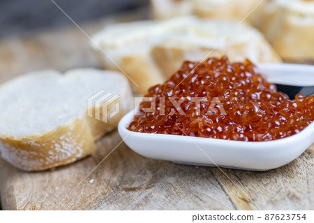 red salmon or trout caviar with white baguette and butter red salmon or trout caviar with white baguette and butter 87623754
