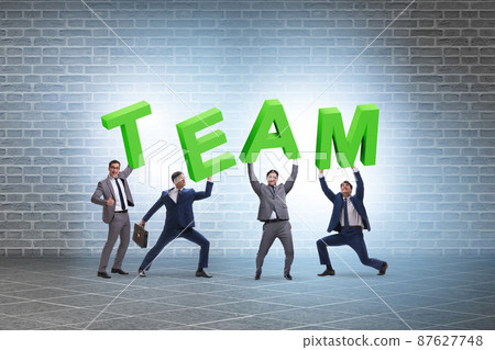 Teamwork concept with people carrying team letters Teamwork concept with people carrying team letters 87627748