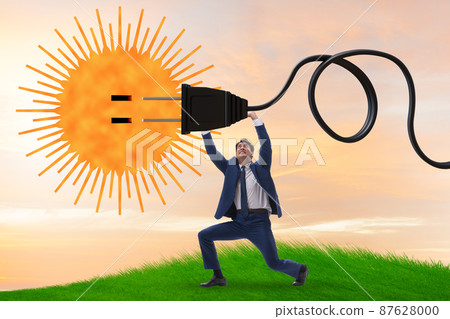 Businessman in solar energy concept Businessman in solar energy concept 87628000