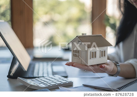 A woman holding and checking house model .Real Estate House Appraisal And Inspection and Insurance concept. 87628728