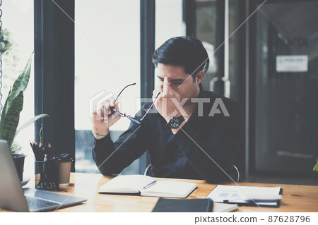 Frustrated stressed business financial or accountant sitting in an office 87628796