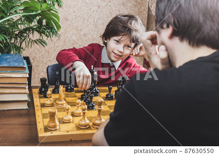 Father and son playing chess at home Father and son playing chess at home 87630550