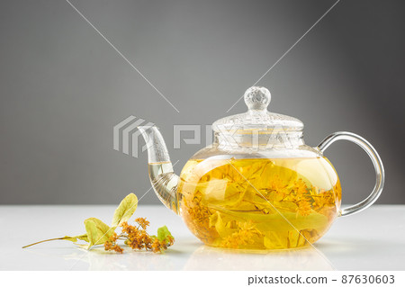 Linden or tilia tea in the transparent tea pot Linden or tilia tea in the transparent tea pot 87630603