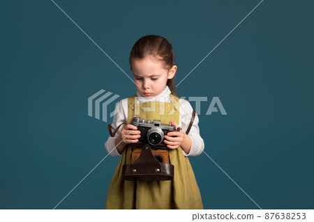 Serious cute little girl about to learn to take pictures 87638253