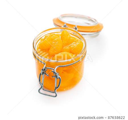Canned tangerine. Pickled mandarin fruit in jar isolated on white background. Canned tangerine. Pickled mandarin fruit in jar isolated on white background. 87638622