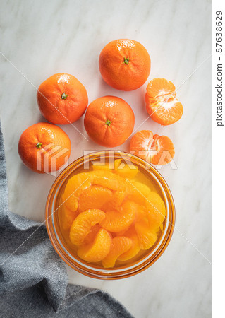 Canned tangerine. Pickled mandarin fruit in bowl. 87638629
