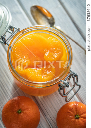 Canned tangerine. Pickled mandarin fruit in jar. 87638640