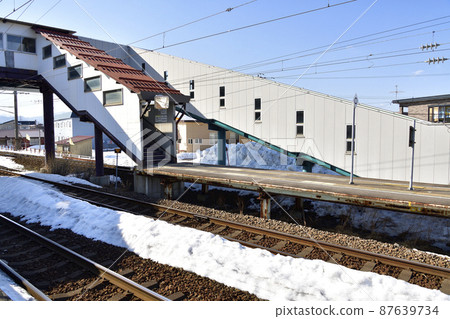 Taking a picture of the scenery of Kunebetsu Station on the South Hokkaido Railway in Hokuto City, Hokkaido in early spring 87639734