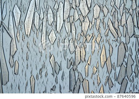 Detail of paint peeling off of a metal surface 87640596