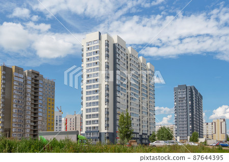 Modern construction, new neighborhood. Beautiful new buildings. Colored wall on the background of blue cloudy sky. Copy space. Modern construction, new neighborhood. Beautiful new buildings. Colored wall on the background of blue cloudy sky. Copy space. 87644395