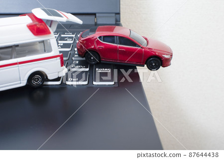 Black keyboard and one ambulance and red car Black keyboard and one ambulance and red car 87644438