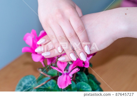 Beauty woman hands with pink fashion manicure. 87645727
