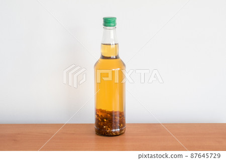 Bottle of amber tincture. Tincture made with spirit and Baltic Sea amber. Bottle of amber tincture. Tincture made with spirit and Baltic Sea amber. 87645729