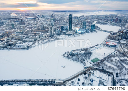 Yekaterinburg aerial panoramic view in Winter at sunset. Yekaterinburg city and pond in winter. 87645798