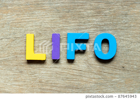 Color alphabet letter in word LIFO (abbreviation of last in first out) on wood background 87645943