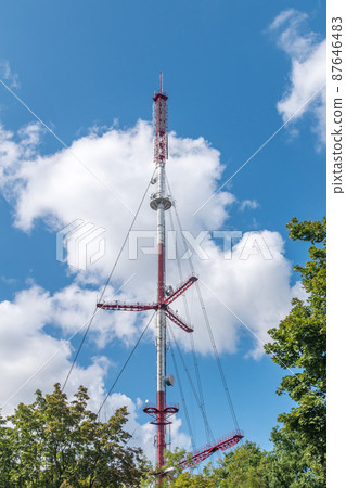 View of Telecommunication tower between trees. View of Telecommunication tower between trees. 87646483