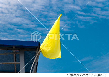 Yellow flag on beach signalise swimming allowed. Yellow flag on beach signalise swimming allowed. 87646485