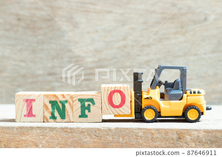 Toy forklift hold letter block o to complete word info on wood background 87646911