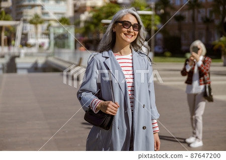 Well dressed female taking stroll through city 87647200