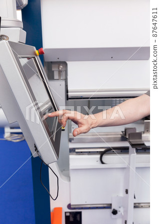 Man working at programmable machine Man working at programmable machine 87647611