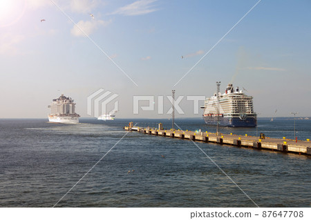 Cruise ship liner goes into horizon the blue sea leaving port. water seascape concept of sea travel Cruise ship liner goes into horizon the blue sea leaving port. water seascape concept of sea travel 87647708