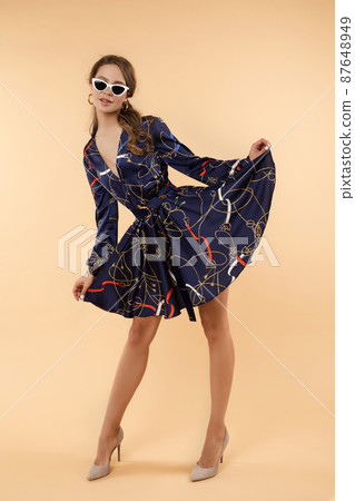 Elegant brunette woman in dress and heels and 87648949