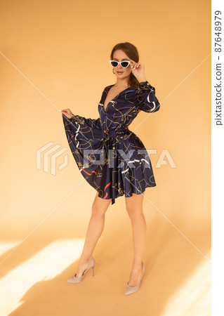 Elegant brunette woman in dress and heels and Elegant brunette woman in dress and heels and 87648979