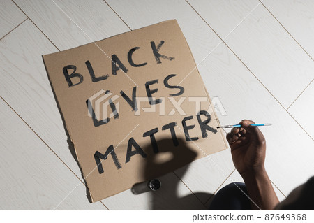 Black lives matter and fight against racism and write sign and words on cardboard - protest concept and blm activism 87649368