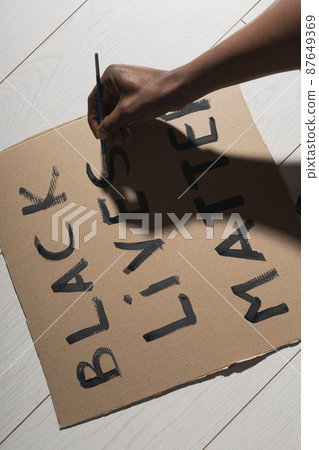 Black lives matter and fight against racism and write sign and words on cardboard - protest concept and blm activism Black lives matter and fight against racism and write sign and words on cardboard - protest concept and blm activism 87649369