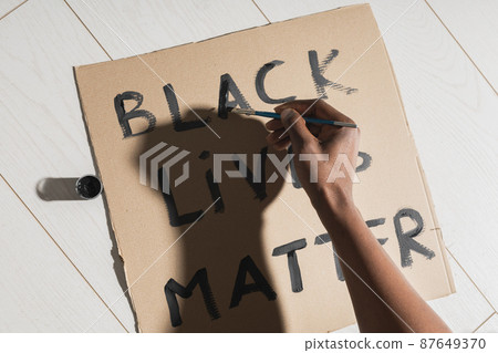 Black lives matter and fight against racism and write sign and words on cardboard - protest concept and blm activism Black lives matter and fight against racism and write sign and words on cardboard - protest concept and blm activism 87649370