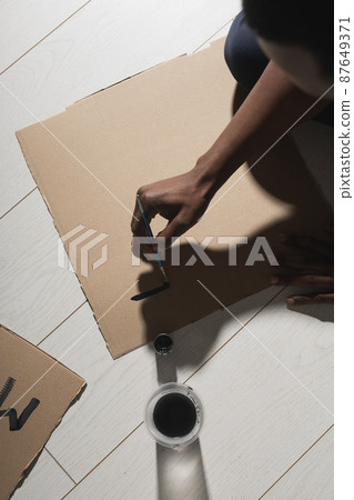 Black lives matter and fight against racism and write sign and words on cardboard - protest concept and blm activism Black lives matter and fight against racism and write sign and words on cardboard - protest concept and blm activism 87649371