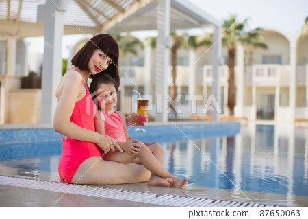 Happy family in the pool, having fun, mother with baby girl on summer holidays vacation. Happy family in the pool, having fun, mother with baby girl on summer holidays vacation. 87650063