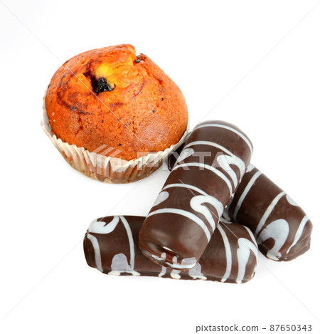 Cookies and muffins isolated on white . 87650343