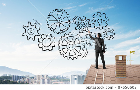 Mister boss on brick roof standing with back and draw teamwork concept. Mixed media 87650602