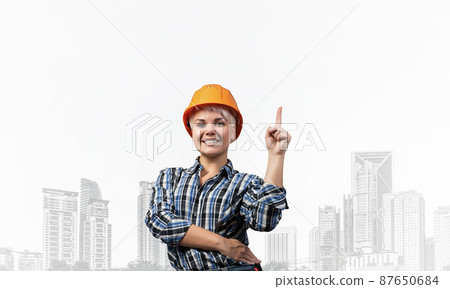 Beautiful female builder in hardhat 87650684