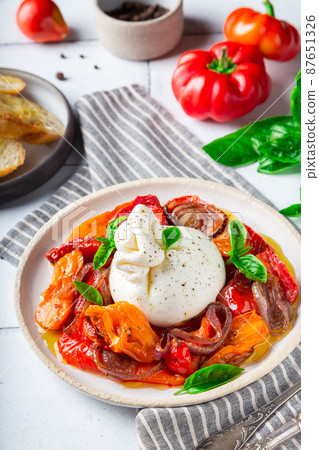 Burrata cheese with baked tomatoes, pepper, red onion and fresh 87651326