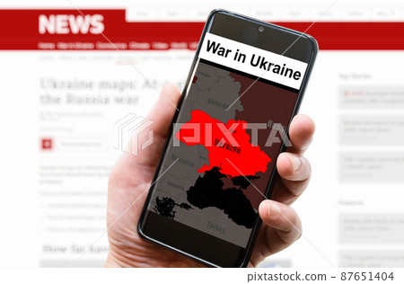 War in Ukraine on mobile phone screen, media news concept 87651404