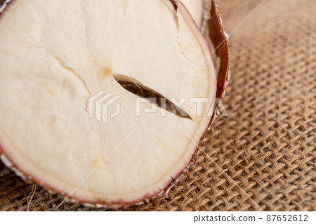 Yucca cassava sliced root with crack close up on rustic rough burlap. Macro shot Yucca cassava sliced root with crack close up on rustic rough burlap. Macro shot 87652612