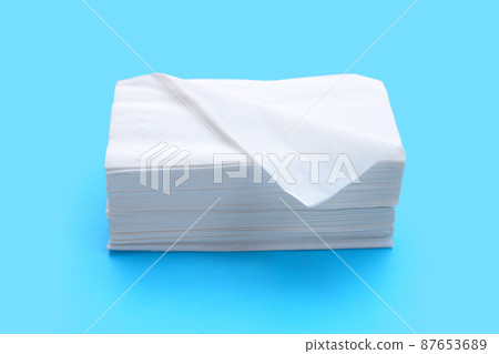 Facial tissue on blue background. 87653689