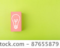 Creativity, innovation and idea concept. Light bulb drawn on pink rectangle on bright green background with copy space 87655879