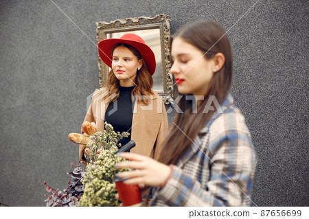 Two young girls standing outdoor and chatting 87656699