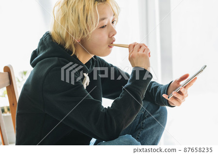 一個拿著智能手機刷牙的女人 87658235