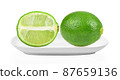 green lemon in white plate on white background 87659136