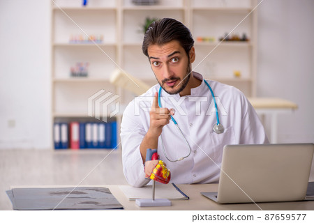 Young male doctor cardiologist working in the clinic 87659577